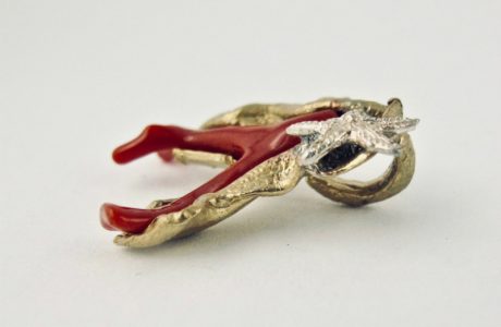 Pendentif ramo,  branche de véritable corail rouge de Méditerranée enveloppée d'une feuille de bronze plaqué or, ornée d'une petite étoile de mer en argent massif.